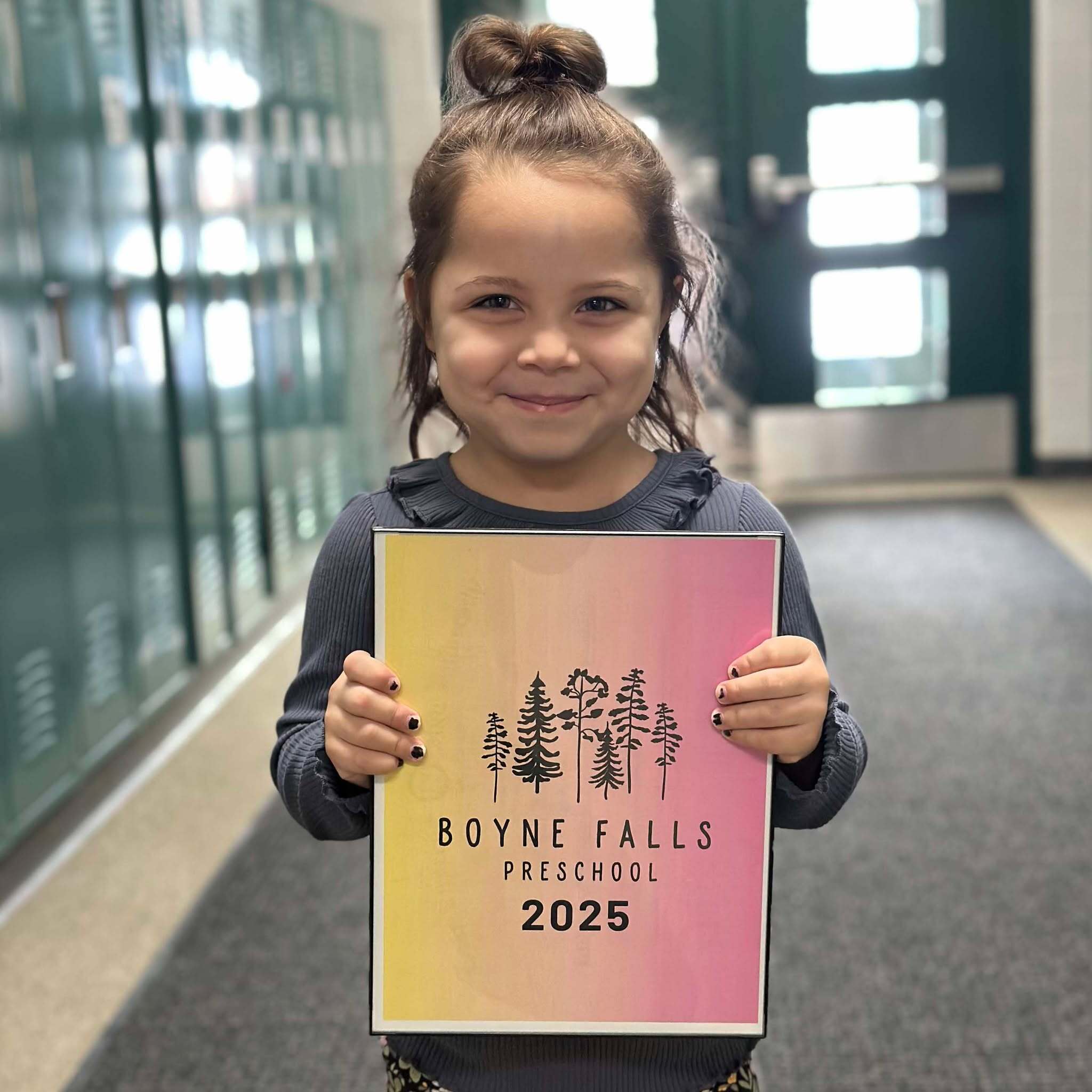 Student holding a Boyne Falls Preschool Sign